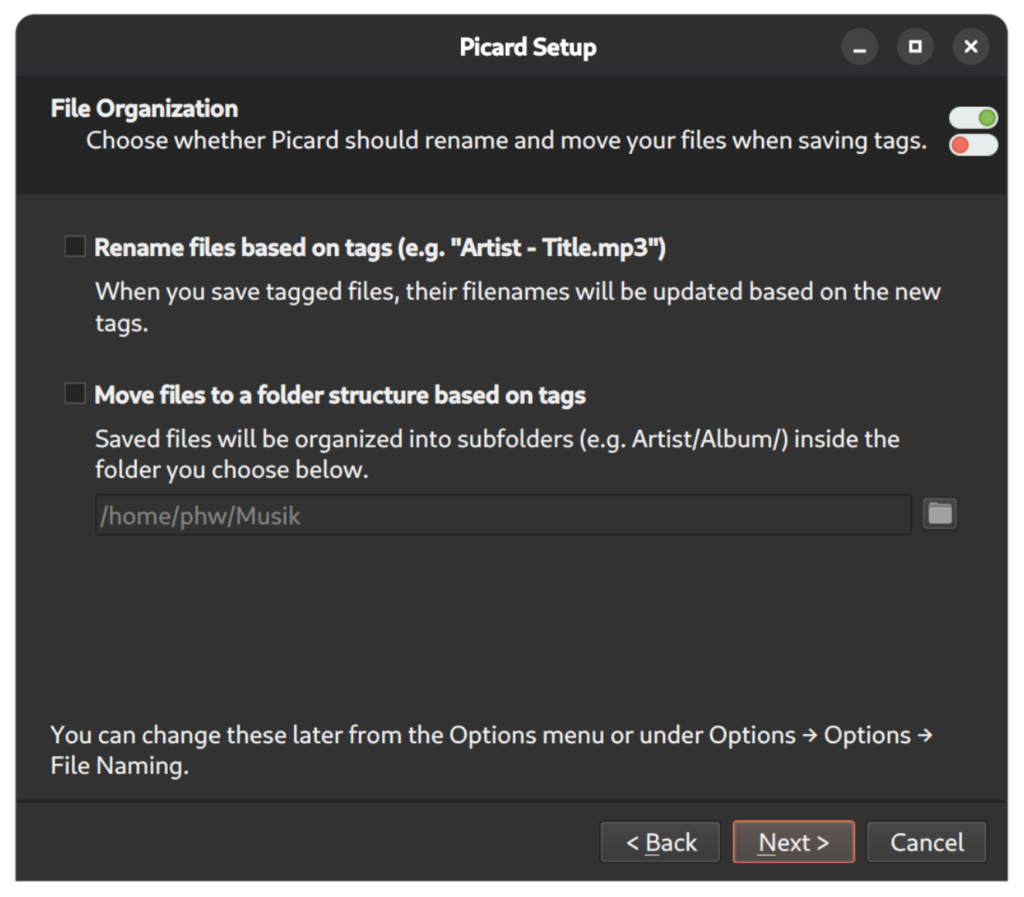 Screenshot of the Picard Setup Wizard dialog to configure File Organization.
It allows toggling the options for "Rename files based on tags" and "Move files to a folder structure based on tags". Each option is shown with a more detailed expalantion.